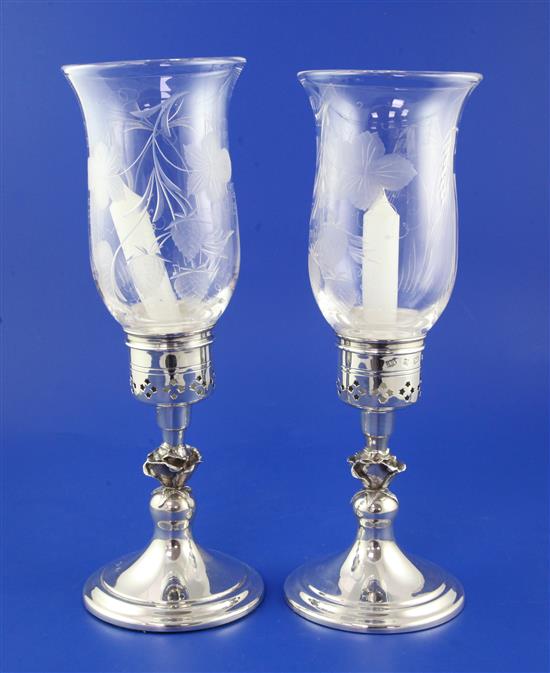 A matched modern pair of silver hurricane lamps with hop-etched glass shades, weighted.